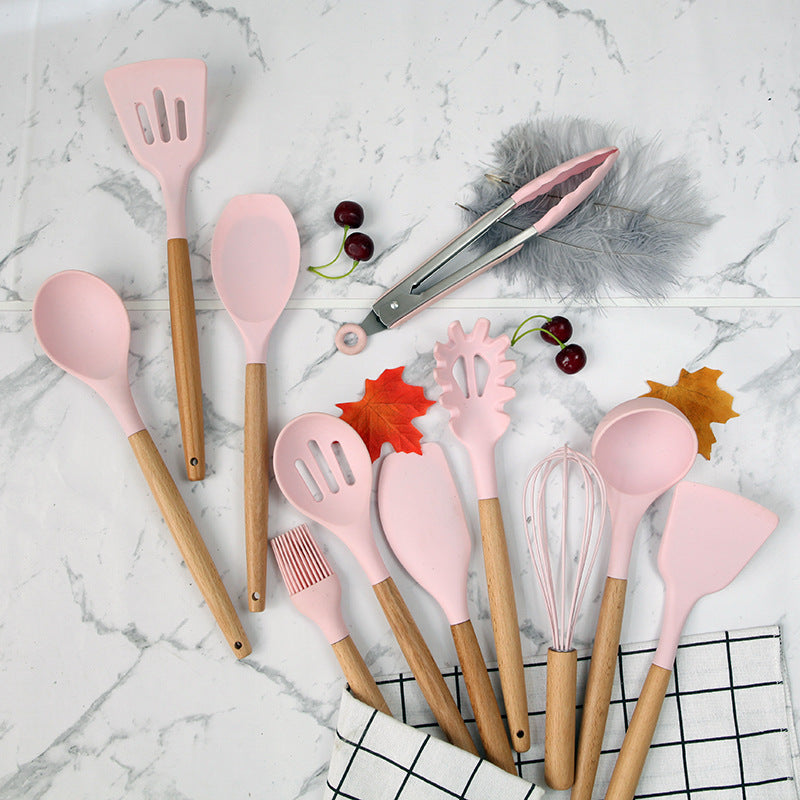 Pink wooden-handled silicone kitchen utensils