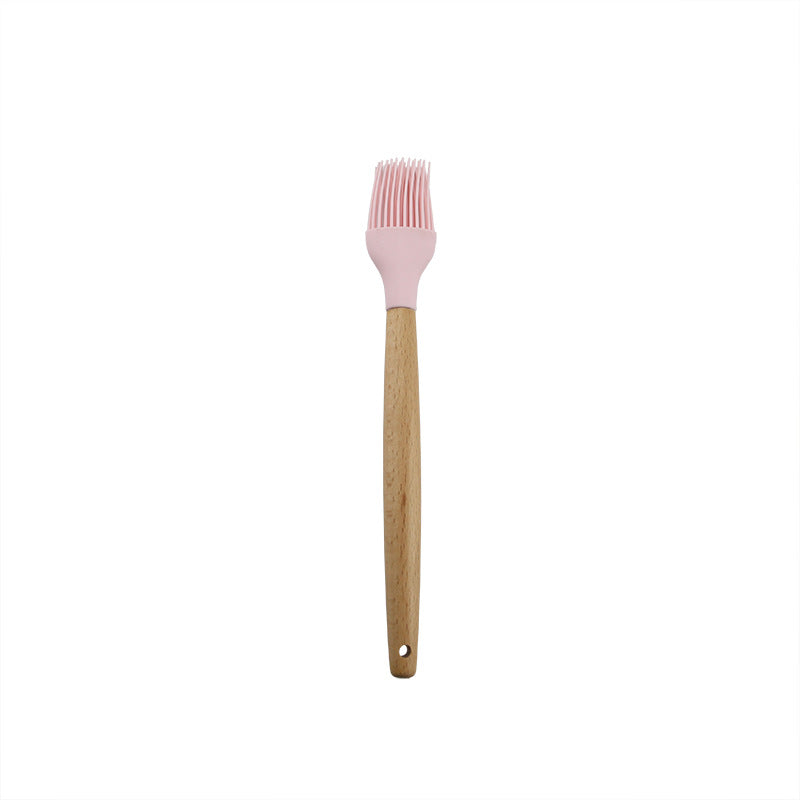 Pink wooden-handled silicone kitchen utensils
